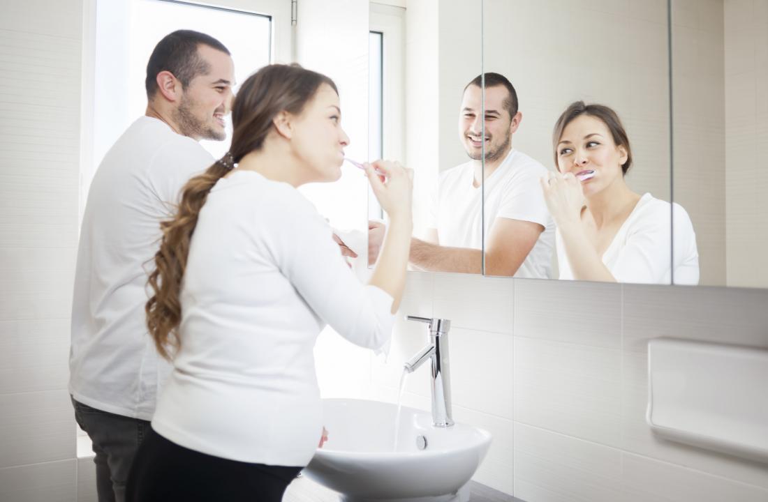 Couple cleaning teeth