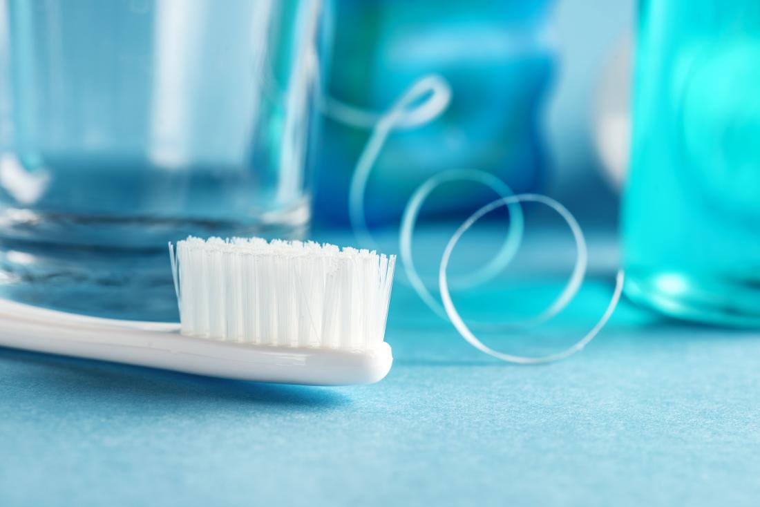 Dental hygiene products including toothbrush, floss, and mouthwash.