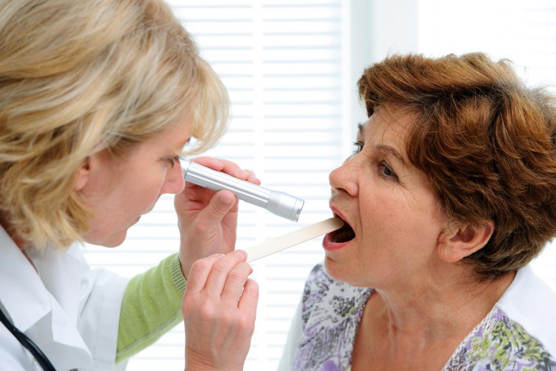 Doctor inspecting patients mouth