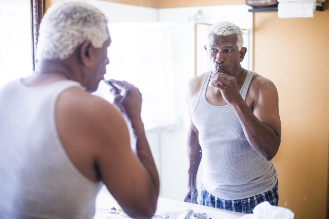 man brushing his teeth