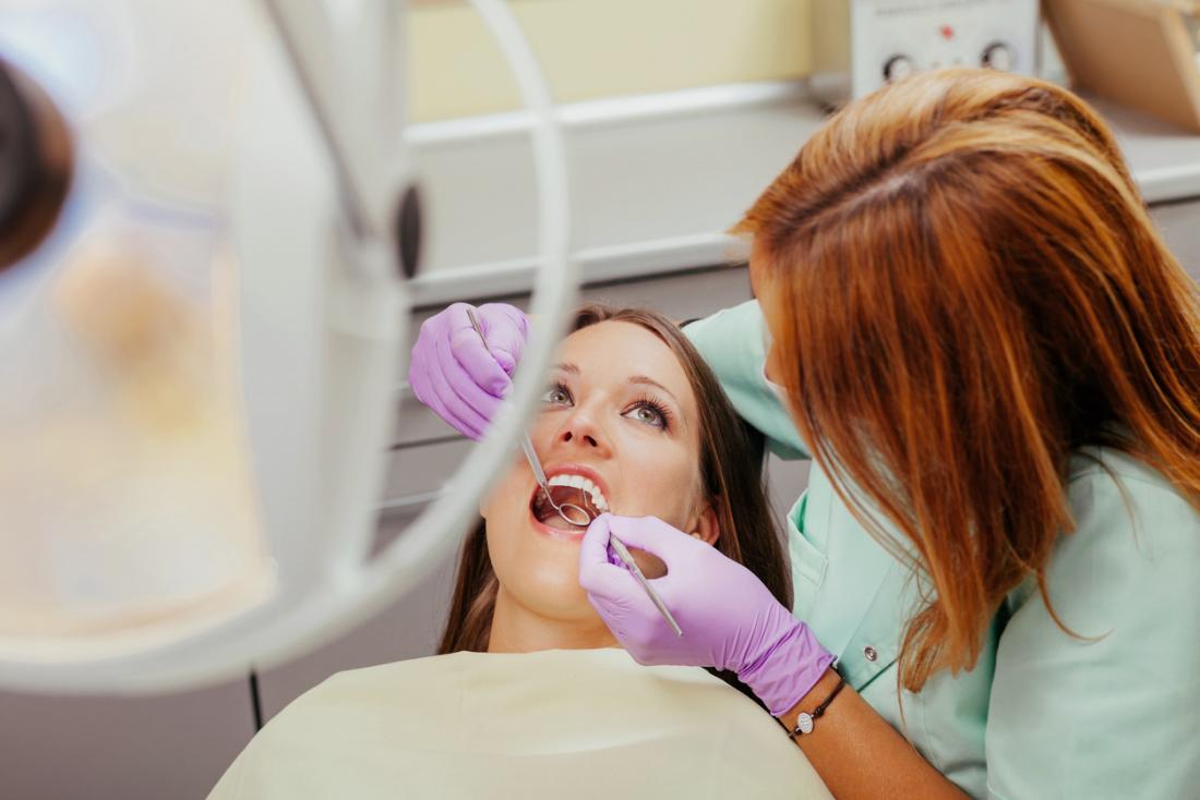 Woman having teeth checked at the dentist