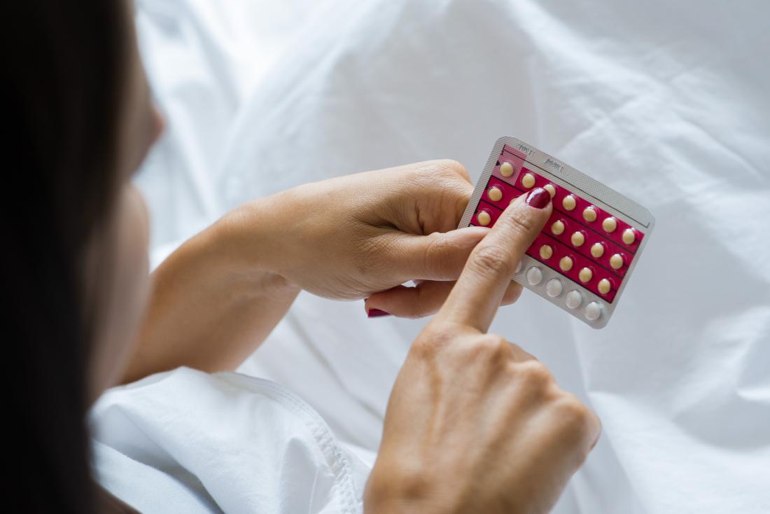 Woman holding pack of birth control pills.